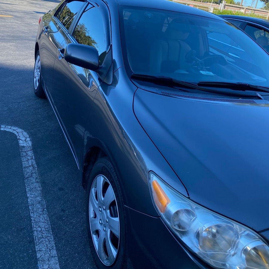 The grey sedan used for DMV behind-the-wheel tests, parked and ready at a Bay Area DMV lot.